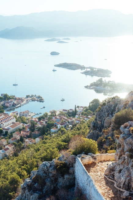 A photo taken from a trail up a mountain, looking over most of the island