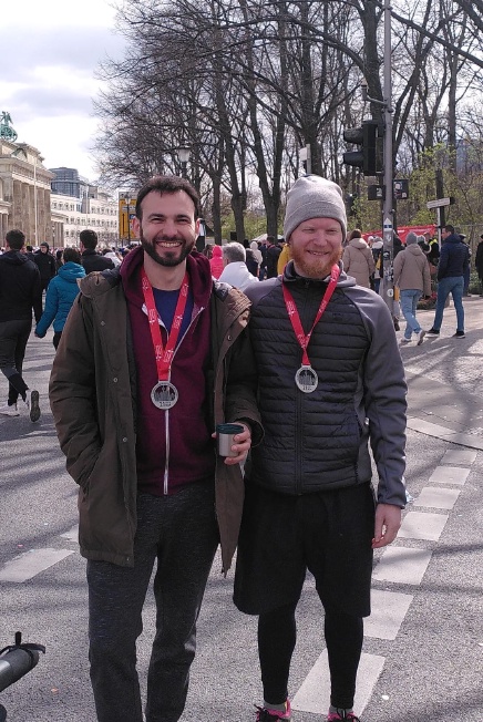 Fabian and Pavel smiling with half marathon medals