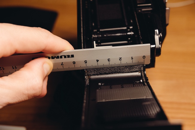 Measuring the length of a piece of light seal foam with a ruler