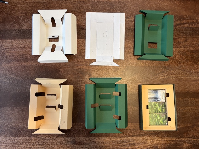 Prototypes from left-to-right:
Original insert that ships with the game. First paper prototype to check that I had the basic geometry right. First cardboard prototype. It&rsquo;s great except I forgot to add the long flaps, which add loads of structural stability. First CAD prototype. Also adds finger holes so that you can lift stacks of cards out easily. I accidentally added extra stability flaps to this one. What was supposed to be the final version, but I messed up sticking the pattern sheets together and it&rsquo;s a centimeter too wide 🥲 Final version. The green looked much better, but I used my last green cardboard on Iteration 5, and it&rsquo;s Sunday so all the stores are closed. Tja. 