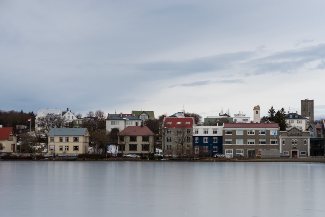 buildings on the edge of a frozen lake