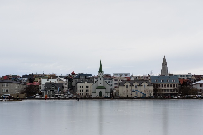 buildings on the edge of a frozen lake, also a church this time