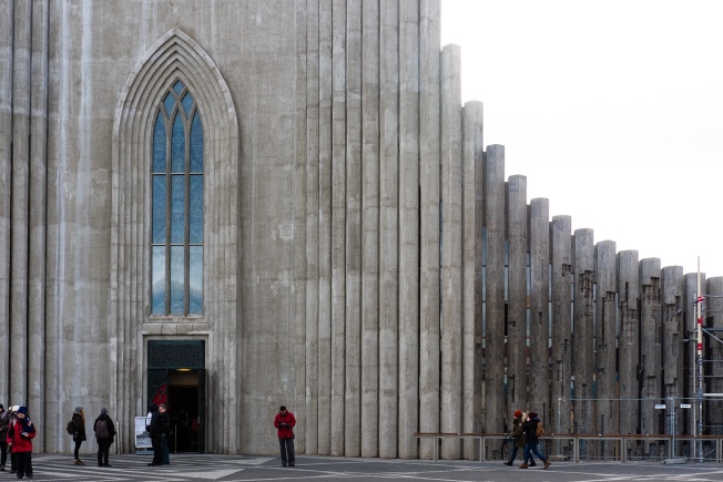 The Hallgrimskirkja, with a reflection of a mountain barely visible in the window